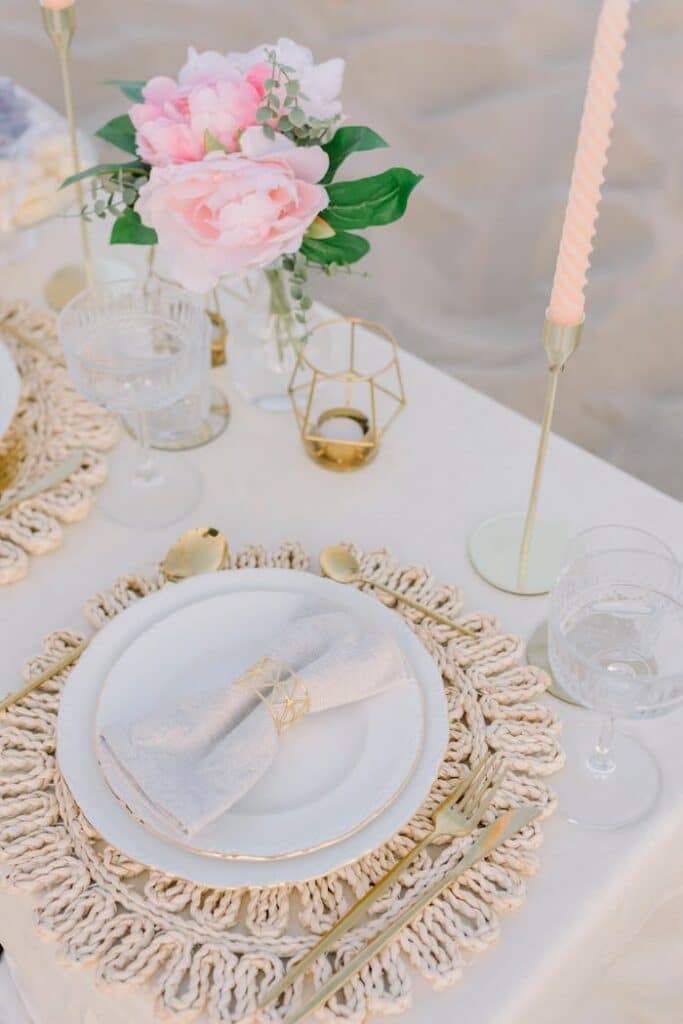 a-table-setting-with-white-plates-and-gold-place-settings-27553420